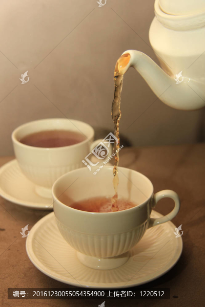 在經(jīng)典的白色茶杯倒茶