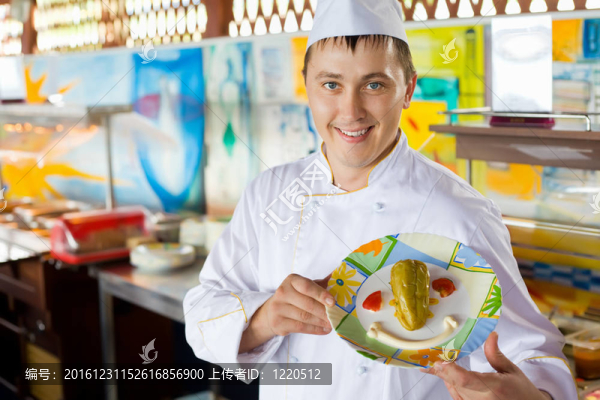 愉快的廚師在統(tǒng)一舉行的手菜與沙拉的形式微笑