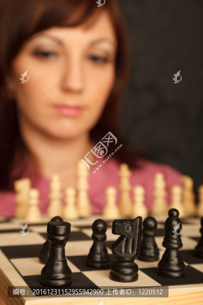 在棋盤上悲傷的看著女孩。特寫。模糊背景。