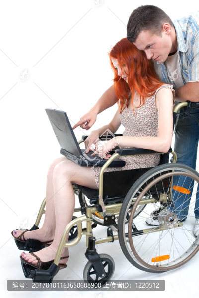在輪椅上有筆記本電腦的女人；帶著男人給她看的東西