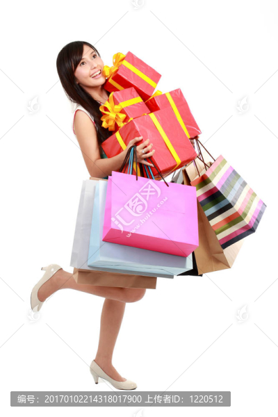 購(gòu)物婦女與五顏六色的袋子和禮品盒。