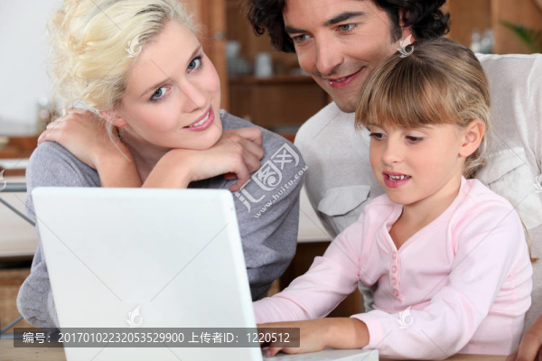 夫婦與他們的女兒和筆記本電腦
