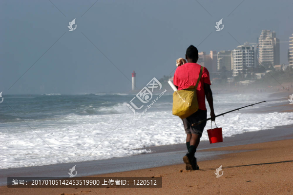 沿著海灘散步的漁夫
