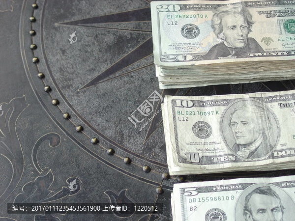 現(xiàn)金散布在一個有圖案的青銅臺面