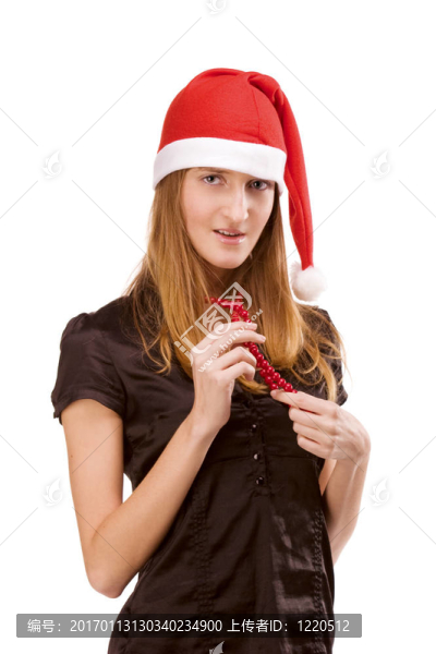 漂亮的女孩在紅色的圣誕老人帽