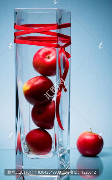 五紅applel和高大的玻璃花瓶上的藍(lán)色