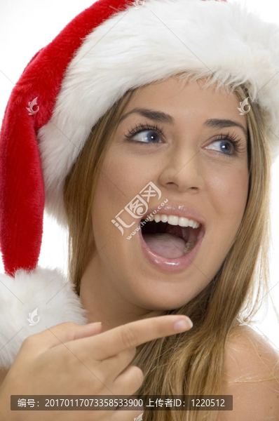 指向性感的女性與圣誕老人帽