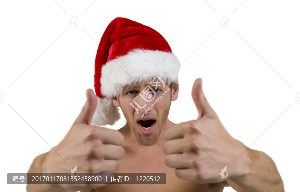 年輕英俊男子戴圣誕老人帽子豎起大拇指