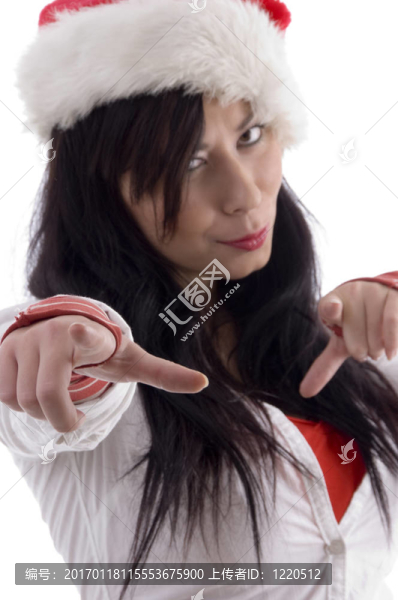 漂亮的女人指著手指戴著圣誕帽