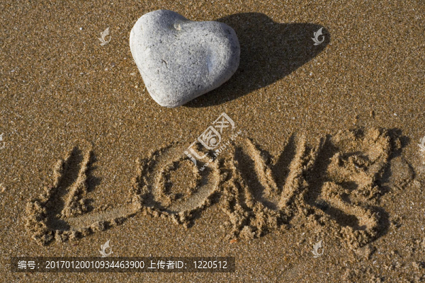 心形石頭和愛的詞在海灘上