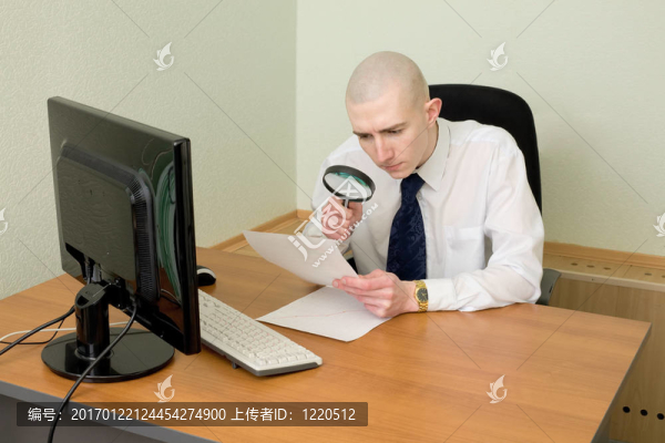 在一個工作場所的放大鏡的商人