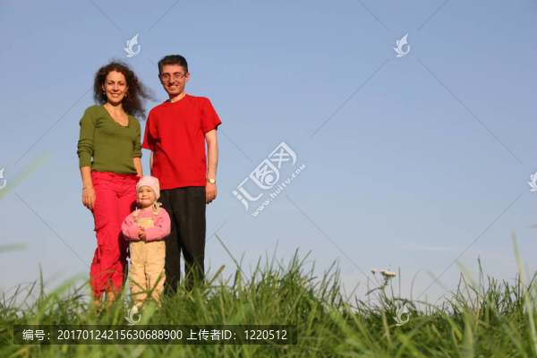 家庭與嬰兒站在草地上