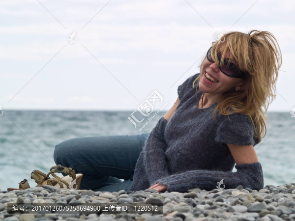 美麗的年輕女士微笑著在Beach
