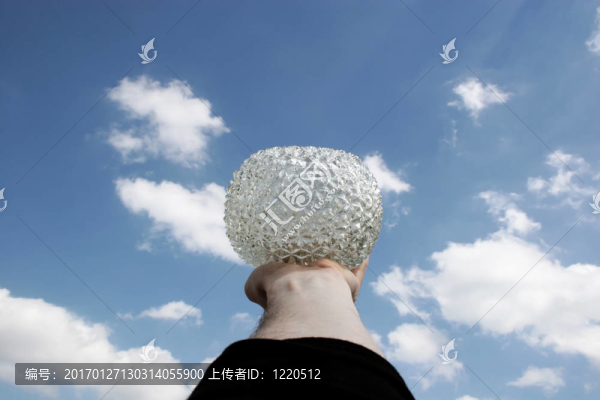 手拿著一個(gè)玻璃碗到天空
