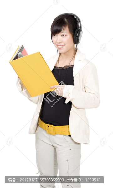 亞洲婦女與黃書(shū)和耳機(jī)