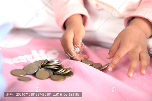 一雙小手正在擺弄?dú)W元硬幣