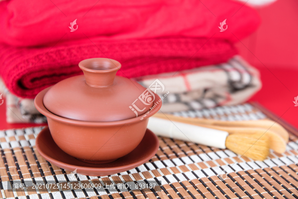疊好衣服旁邊的紫砂蓋碗