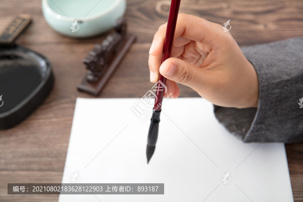 書法家手拿毛筆正要寫字