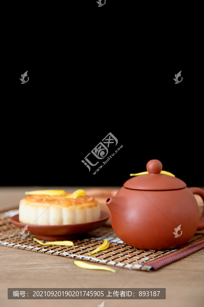 桌子上一壺茶和一塊月餅