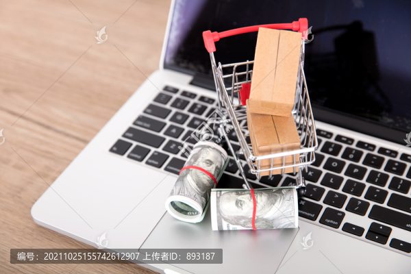 電腦鍵盤上的美金和購物車及快遞