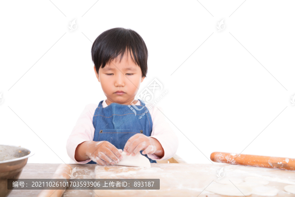 藍色圍裙的亞洲小女孩在包餃子
