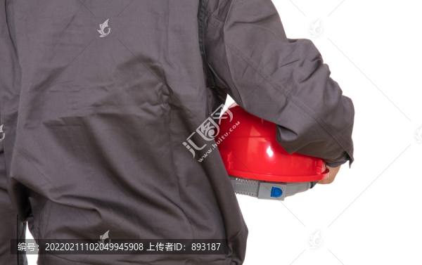 建筑工人手里的紅色安全帽