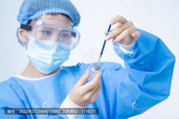 身穿手術(shù)服的女醫(yī)生手拿注射器