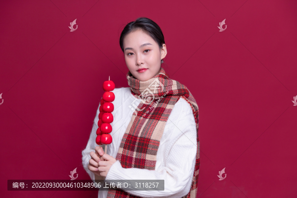 手持冰糖葫蘆的年輕女性