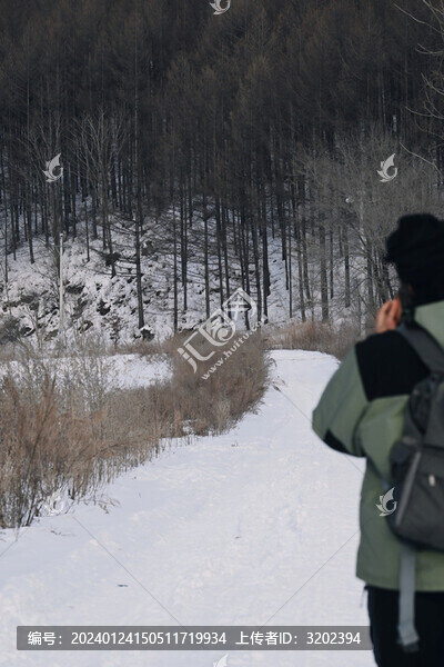在山腳雪地道路上行走的人