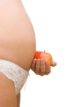 怀孕的女人和一个苹果