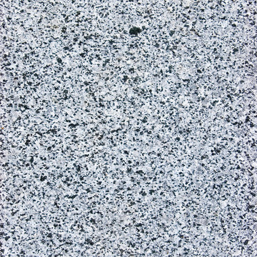 粗糙的切割的花岗岩石材的质感；天然灰色背景；粗斑灰板宏观特写